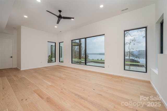 unfurnished room featuring ceiling fan and light wood-type flooring