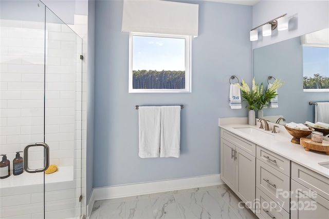 bathroom featuring baseboards, double vanity, a stall shower, marble finish floor, and a sink