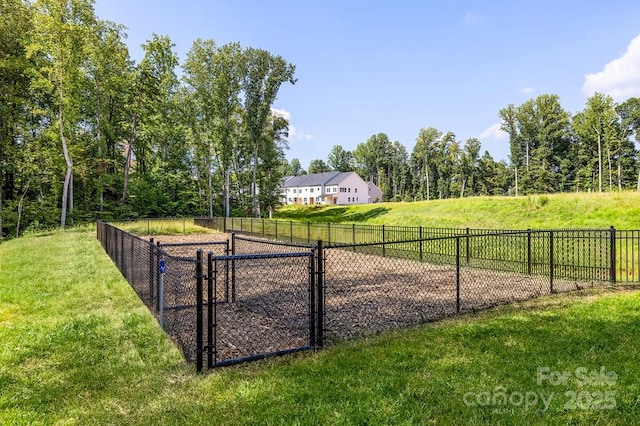 view of home's community with a yard and fence