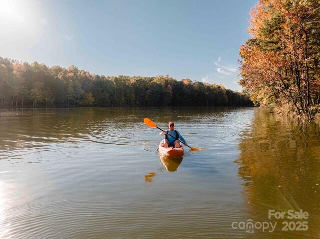 property view of water featuring a forest view