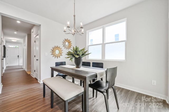 dining space featuring an inviting chandelier, wood finished floors, baseboards, and recessed lighting