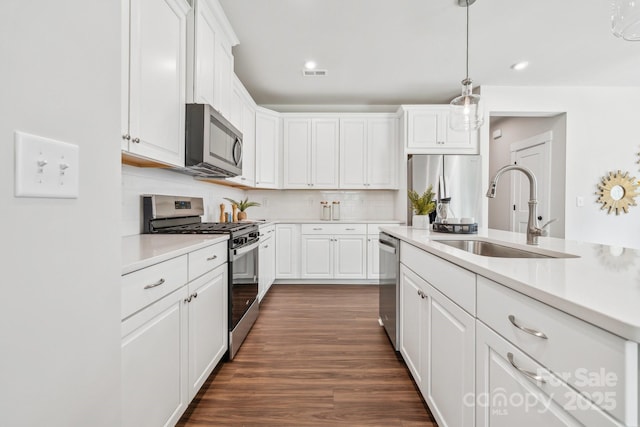 kitchen featuring a sink, visible vents, light countertops, white cabinets, and appliances with stainless steel finishes
