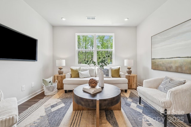 living area with visible vents, wood finished floors, baseboards, and recessed lighting