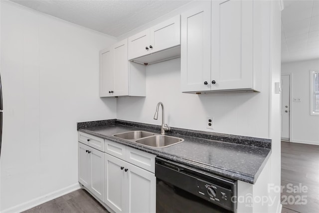 kitchen with dark hardwood / wood-style flooring, black dishwasher, sink, and white cabinets