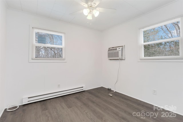 spare room featuring a baseboard radiator, a healthy amount of sunlight, dark hardwood / wood-style floors, and a wall mounted AC