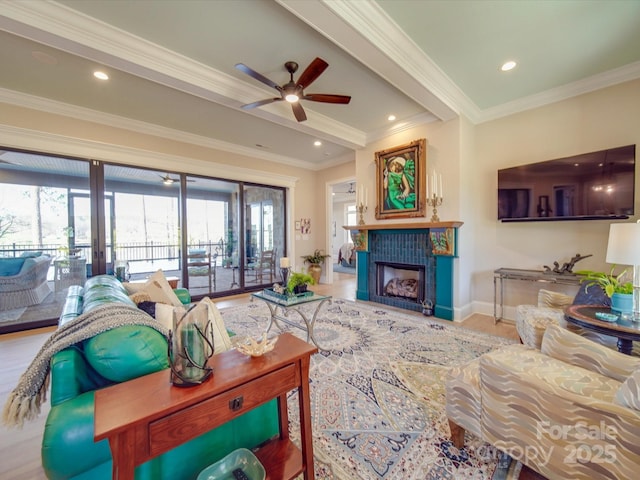 living room with crown molding, ceiling fan, a tile fireplace, and french doors