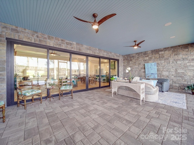 view of patio / terrace featuring ceiling fan and an outdoor living space