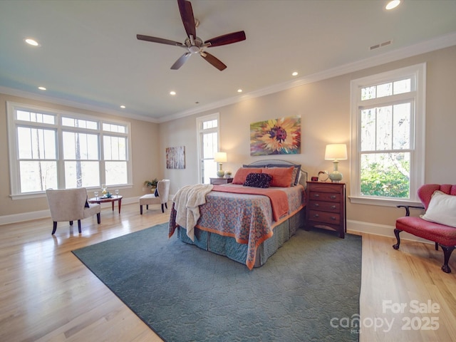 bedroom with ornamental molding and light hardwood / wood-style floors