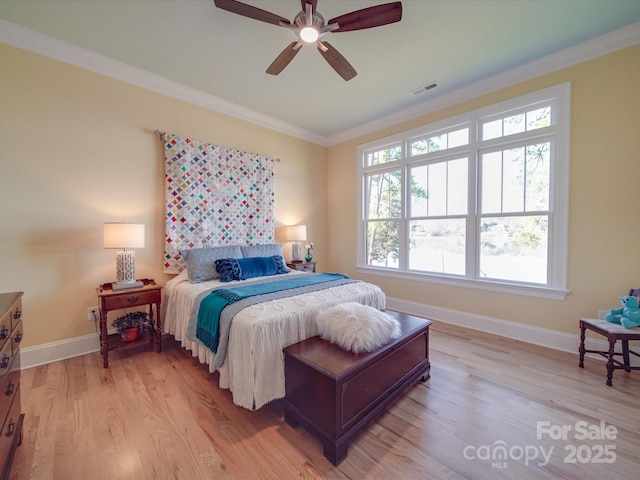 bedroom with crown molding, ceiling fan, and light hardwood / wood-style floors