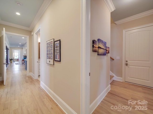 hall with ornamental molding and light wood-type flooring