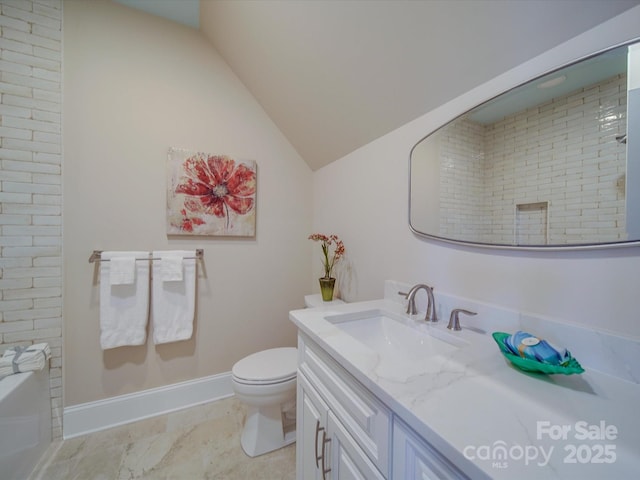 bathroom featuring lofted ceiling, vanity, and toilet