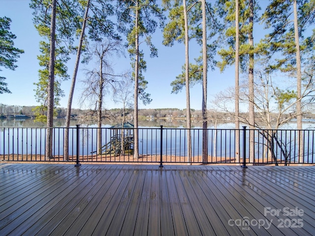 wooden terrace featuring a water view