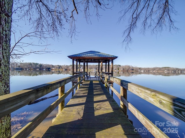 view of dock with a water view and a gazebo