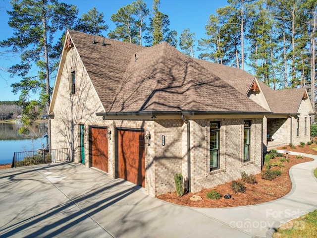 view of front of home featuring a garage and a water view