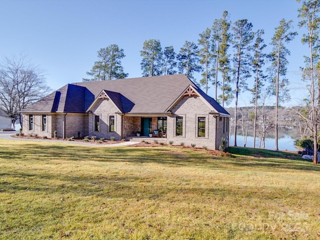 view of front of home with a water view and a front lawn