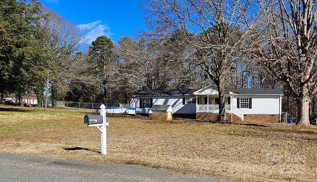 view of front of home with a front yard and a porch