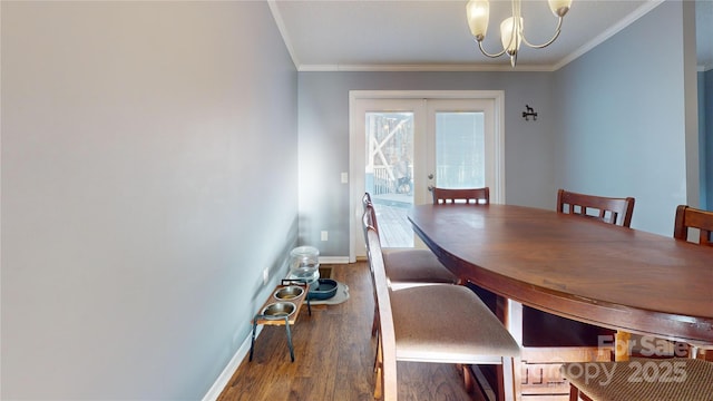 dining area with ornamental molding, hardwood / wood-style floors, an inviting chandelier, and french doors