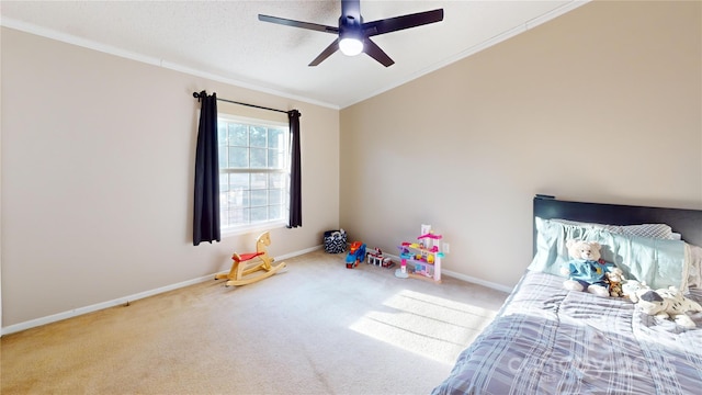 bedroom featuring ceiling fan, light colored carpet, ornamental molding, and a textured ceiling