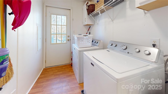 washroom with separate washer and dryer and light wood-type flooring