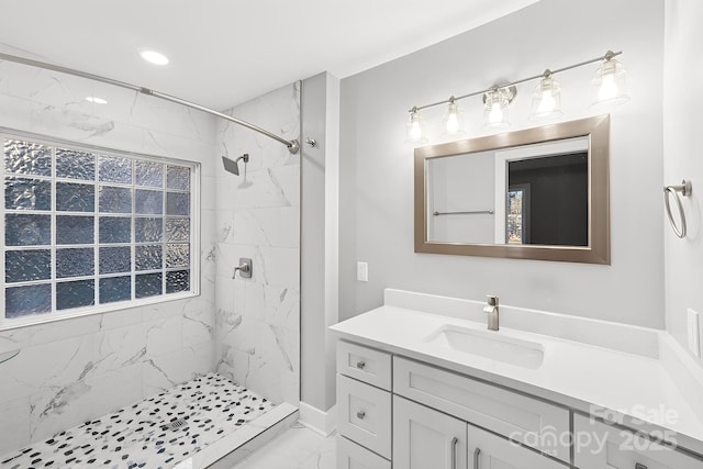 bathroom with vanity and tiled shower