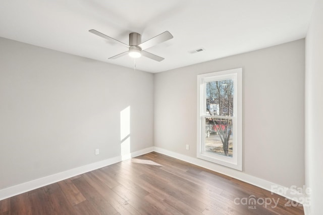 unfurnished room with hardwood / wood-style floors and ceiling fan