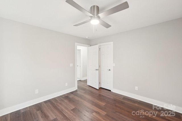 unfurnished bedroom with dark wood-type flooring and ceiling fan