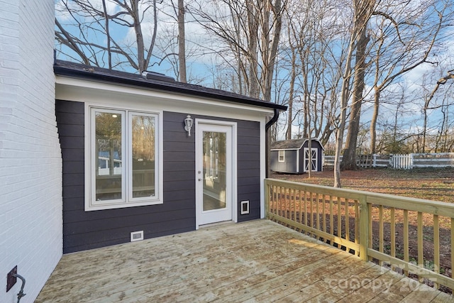 wooden deck with a storage shed