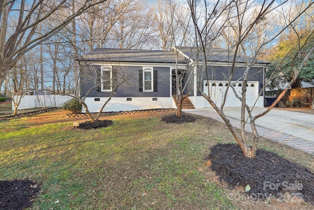 ranch-style house with a garage and a front lawn