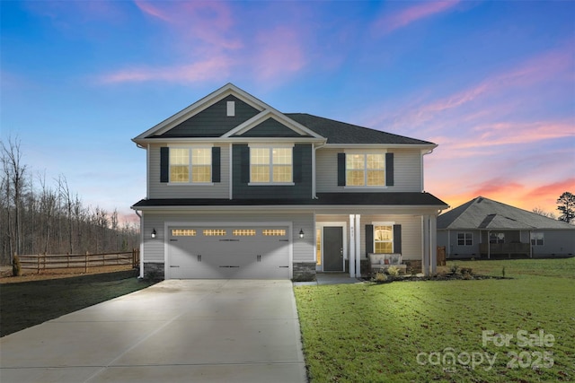 view of front of home featuring a garage and a lawn