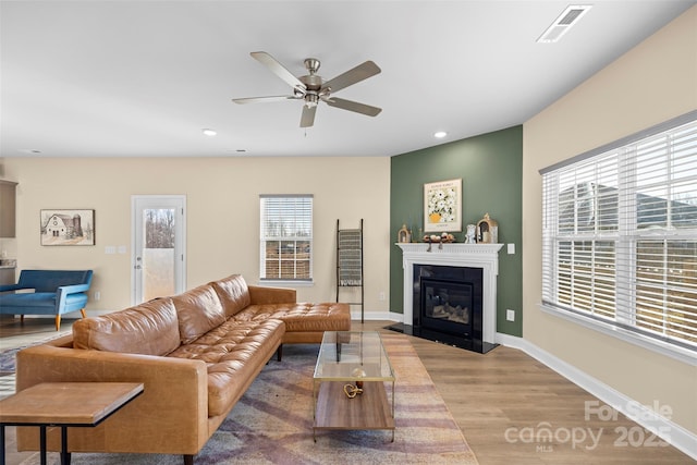 living room with a healthy amount of sunlight, hardwood / wood-style floors, and ceiling fan