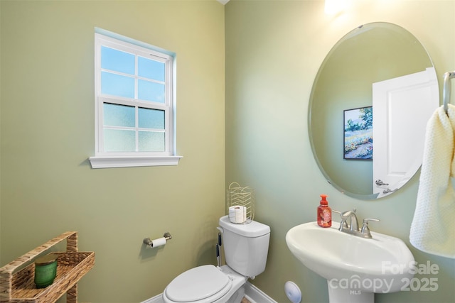 bathroom featuring toilet and sink