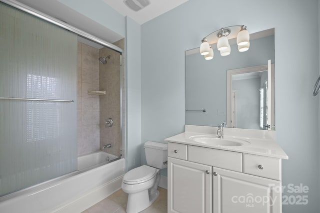 full bathroom featuring bath / shower combo with glass door, vanity, tile patterned floors, and toilet