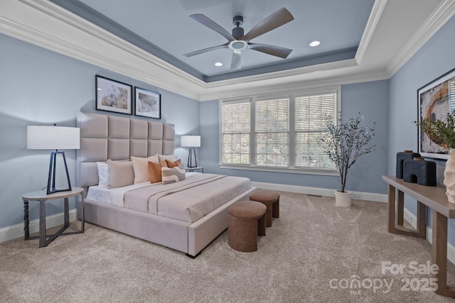 bedroom featuring a raised ceiling, crown molding, light carpet, and ceiling fan