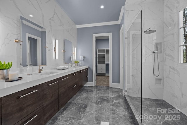 bathroom featuring crown molding, vanity, a wealth of natural light, and a tile shower