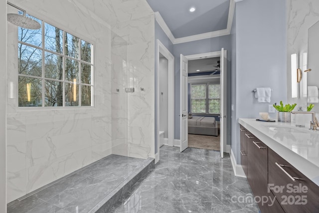 bathroom featuring ornamental molding, vanity, and a tile shower