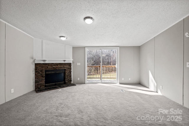 unfurnished living room featuring a fireplace, carpet, and a textured ceiling