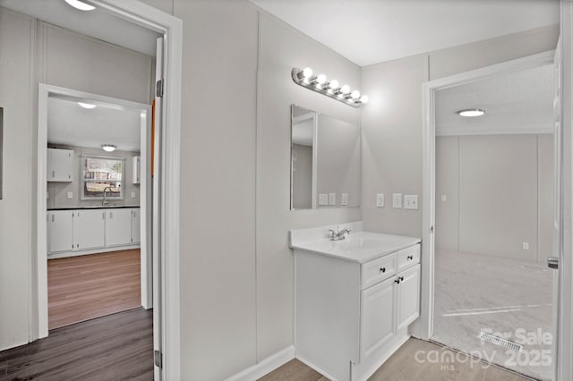 bathroom with vanity and hardwood / wood-style floors