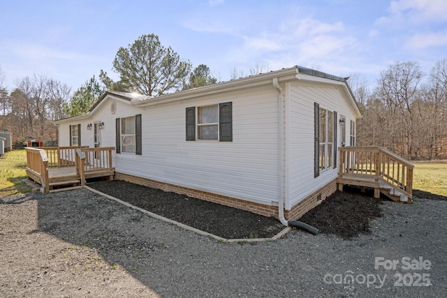 view of side of property featuring a wooden deck