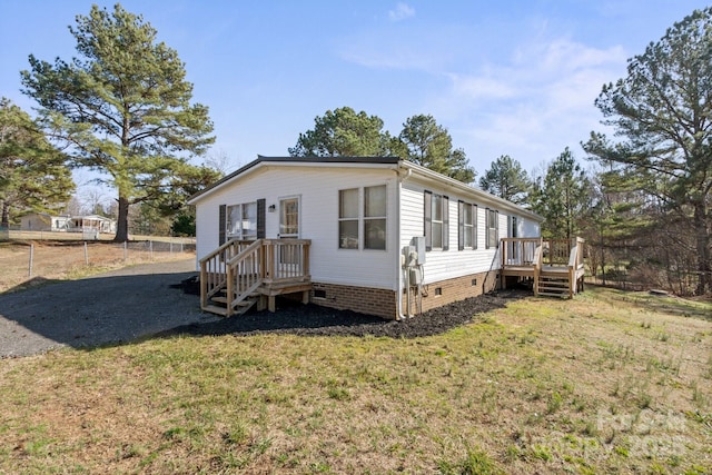 exterior space featuring a wooden deck and a yard