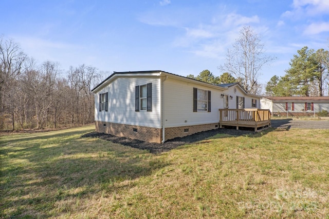 view of property exterior with a wooden deck and a yard