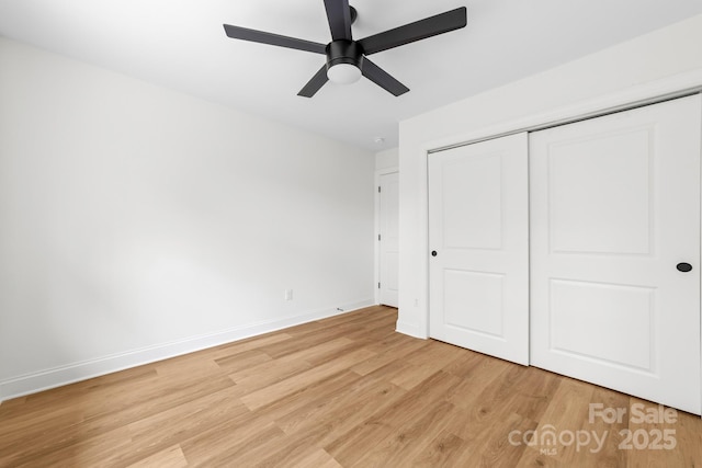 unfurnished bedroom with baseboards, ceiling fan, light wood-style flooring, and a closet