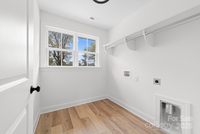laundry area featuring light wood-style flooring, hookup for a washing machine, baseboards, laundry area, and hookup for an electric dryer
