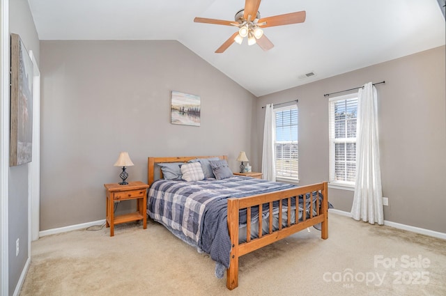 bedroom with ceiling fan, lofted ceiling, and light carpet