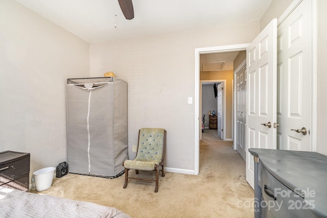 living area with light colored carpet and ceiling fan