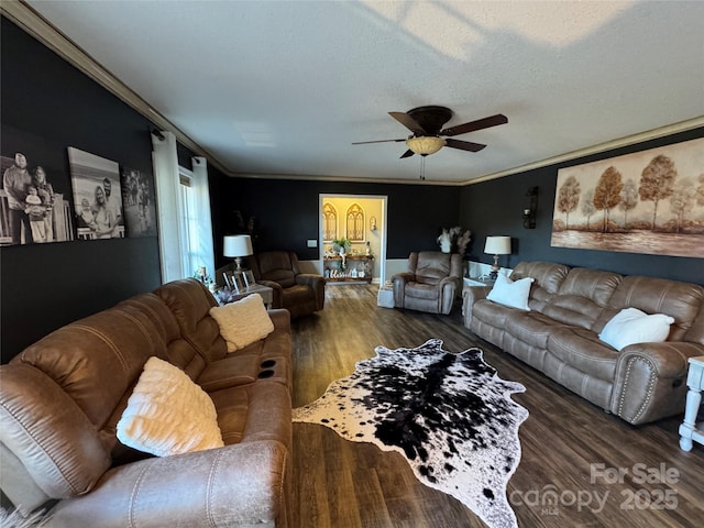 living room featuring crown molding, ceiling fan, dark hardwood / wood-style flooring, and a textured ceiling