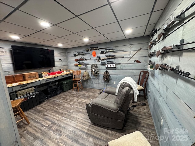 interior space with dark hardwood / wood-style floors and a drop ceiling