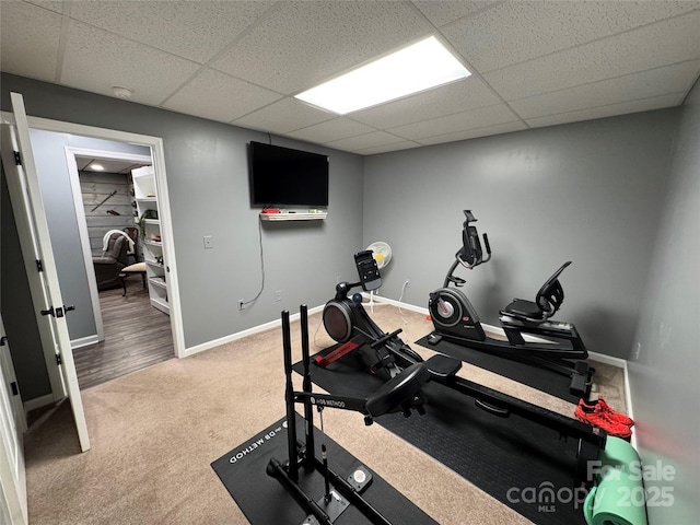 exercise room with carpet and a drop ceiling