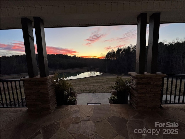 patio terrace at dusk with a water view