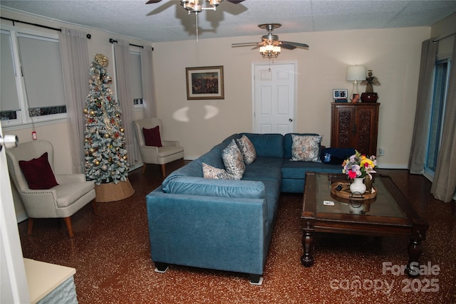 living room with ceiling fan and a textured ceiling