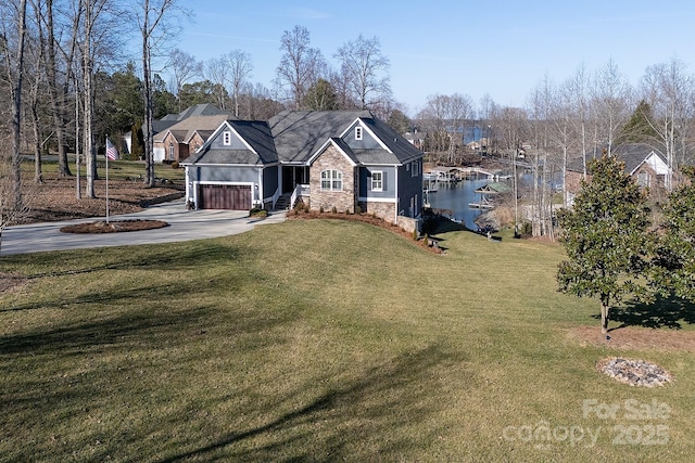 view of front of house featuring a water view, a garage, and a front yard